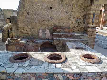 The Thermopolium of the ancient city of Herculaneum. This is the place where warm food was kept in the amphorae and ready to eat.